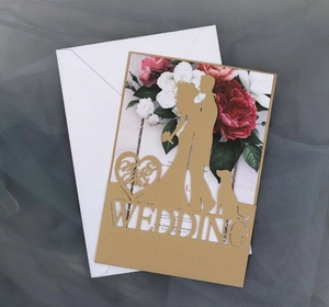 Laser cut wedding invitation set with floral inner card and white envelope detail