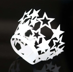 Close-up of white star lace hollow paper cake wrappers with laser-cut star patterns