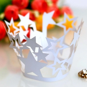 Detailed close-up of white star-shaped hollow lace cupcake wrapper for party decoration