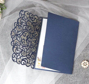 Detailed laser-cut vine patterns on dark blue cardstock with floral inner card