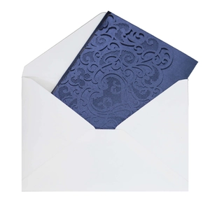 Detail of laser-cut floral wedding invitation card in navy blue with premium white envelope