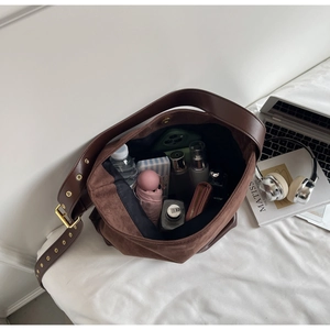 Detail view of large dark brown suede tote bag showing interior storage capacity