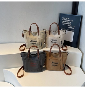 Minimalist canvas tote bags with leather straps in four neutral colors on white stand