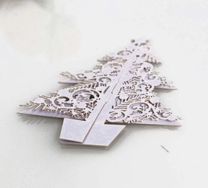 3D laser-cut white paper Christmas tree tabletop decoration with intricate floral patterns
