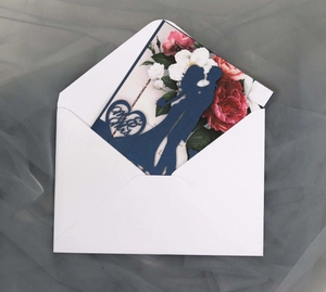 Laser-cut wedding invitation featuring Mr & Mrs silhouette and colorful floral accents