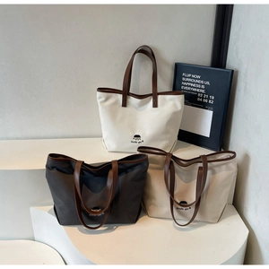 Detailed comparison of canvas tote bags in white, dark grey, and beige with leather trim