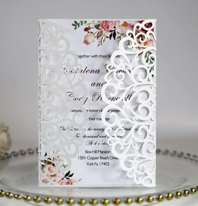 Macro detail of laser-cut lace wedding invitation with elegant floral printing pattern