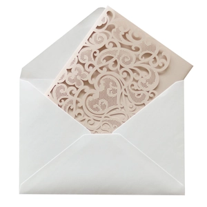 Detail of laser-cut heart vine pattern on pearlescent paper invitation with envelope