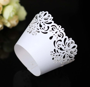 Elegant white laser-cut cupcake wrappers with floral lace pattern for dessert decoration