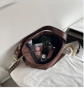 Detailed interior of vintage brown suede shoulder bag showing large storage capacity