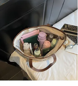 Spacious interior of canvas tote bag filled with tablet and daily essentials for travel