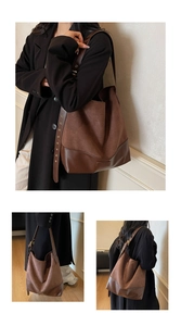 Close-up of vintage coffee brown suede tote bag with adjustable multi-eyelet leather strap