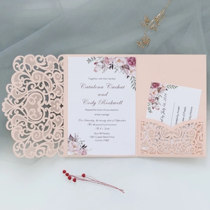 Detail of laser-cut floral wedding invitation with watercolor insert and RSVP card