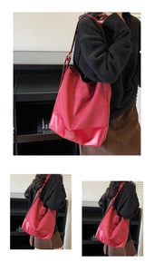 Macro shot of red hobo bag showing faux suede texture, leather strap, and metal buckle detail