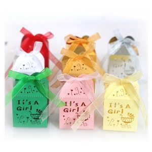 Laser-cut baby shower candy boxes with It's A Girl text and ribbon bows in various colors