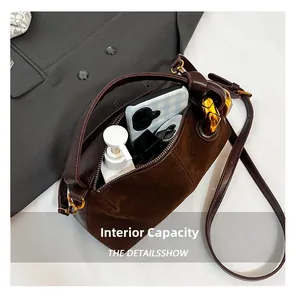 Detail view of the brown shoulder bag's spacious interior and daily essentials storage