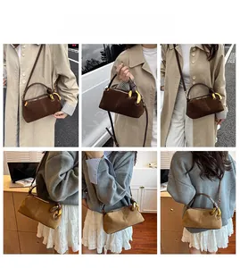 Detail showing vintage suede handbag with metallic handle and slim leather shoulder strap