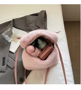 Internal view of pink plush backpack showing spacious storage for umbrella and bottle