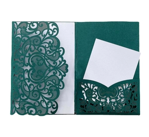 Detailed laser-cut heart scrollwork on dark green wedding invitation cards set
