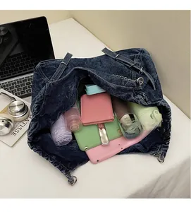 Spacious interior of washed denim tote bag showing capacity for laptop and daily items