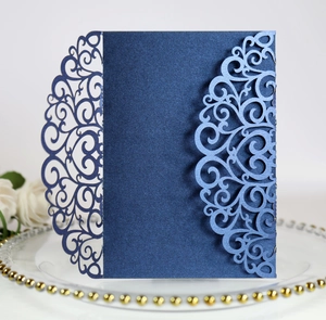 Detailed laser-cut floral pattern on navy blue pearlescent paper wedding invitation cover