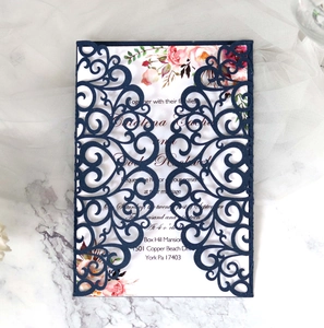 Detailed laser-cut navy blue glitter wedding invitation with elegant floral patterns