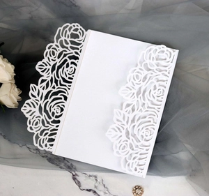 Elegant white laser-cut wedding invitation featuring intricate rose lace pattern details
