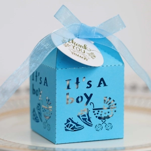 Light blue laser-cut baby shower candy box with boy pram design and blue ribbon