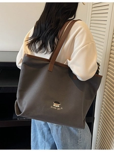 Minimalist large canvas tote bag with letter embroidery and leather handles for travel