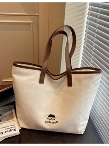 Large beige canvas tote bag with brown leather handles and cute girl embroidery