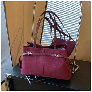 Détail du sac cabas en daim bordeaux avec doubles bretelles et boucles argentées