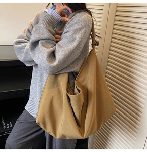 Detail of knot strap on khaki suede tote bag for women showing soft texture and style
