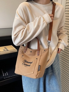 Brown canvas shoulder tote bag with adjustable strap and vintage pocket design