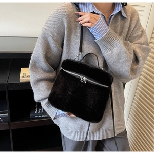 Chic black faux fur box-shaped crossbody bag with smooth leather strap and zipper detail