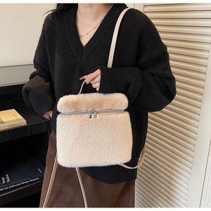 Model wearing a minimalist beige plush crossbody bag with zipper detail for autumn style
