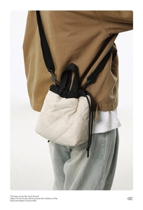 Quilted nylon bucket bag with drawstring closure and contrasting black shoulder strap