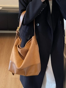 Brown suede tote bag with contrast leather panel and adjustable shoulder strap for women