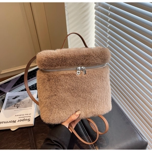 Detail of soft brown faux fur texture and silver zipper on this autumn women's backpack