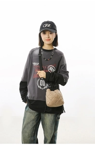 Khaki quilted nylon bucket bag styled with a streetwear outfit and a casual sweatshirt