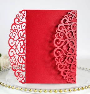 Detailed laser-cut floral pattern on elegant red pearlescent wedding invitation card