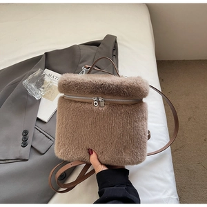 Close-up of soft brown faux fur texture and silver metal zipper on the fashion backpack