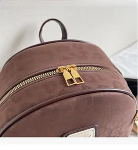 Detailed close-up of smooth gold double zippers on a brown leopard texture backpack
