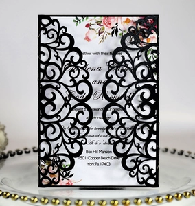 Detail of laser-cut black glitter lace wedding invitation with floral insert