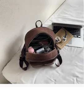 Brown leopard-patterned backpack showing large capacity interior with striped lining