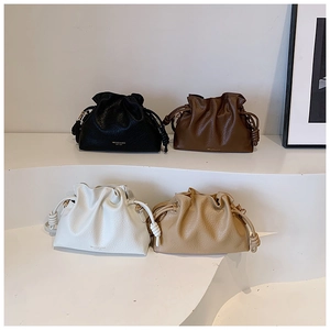 Detailed view of drawstring bucket bags in four colors with knotted shoulder straps