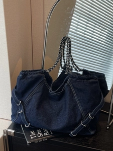 Large denim tote bag with metal chain straps and trendy drawstring design for women