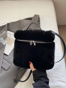 Minimalist black faux fur handbag with leather handle and silver zipper for women