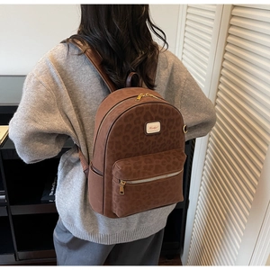 Close-up of brown leopard print backpack showing high-quality suede texture and zipper