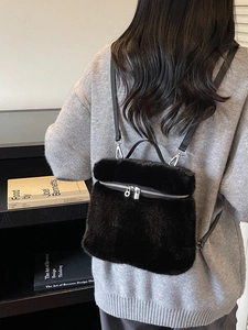 Minimalist black faux fur backpack for women with slim straps and silver hardware