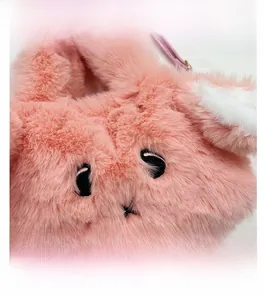 Detail of pink plush rabbit bag featuring cute black embroidery eyes and cross-shaped mouth